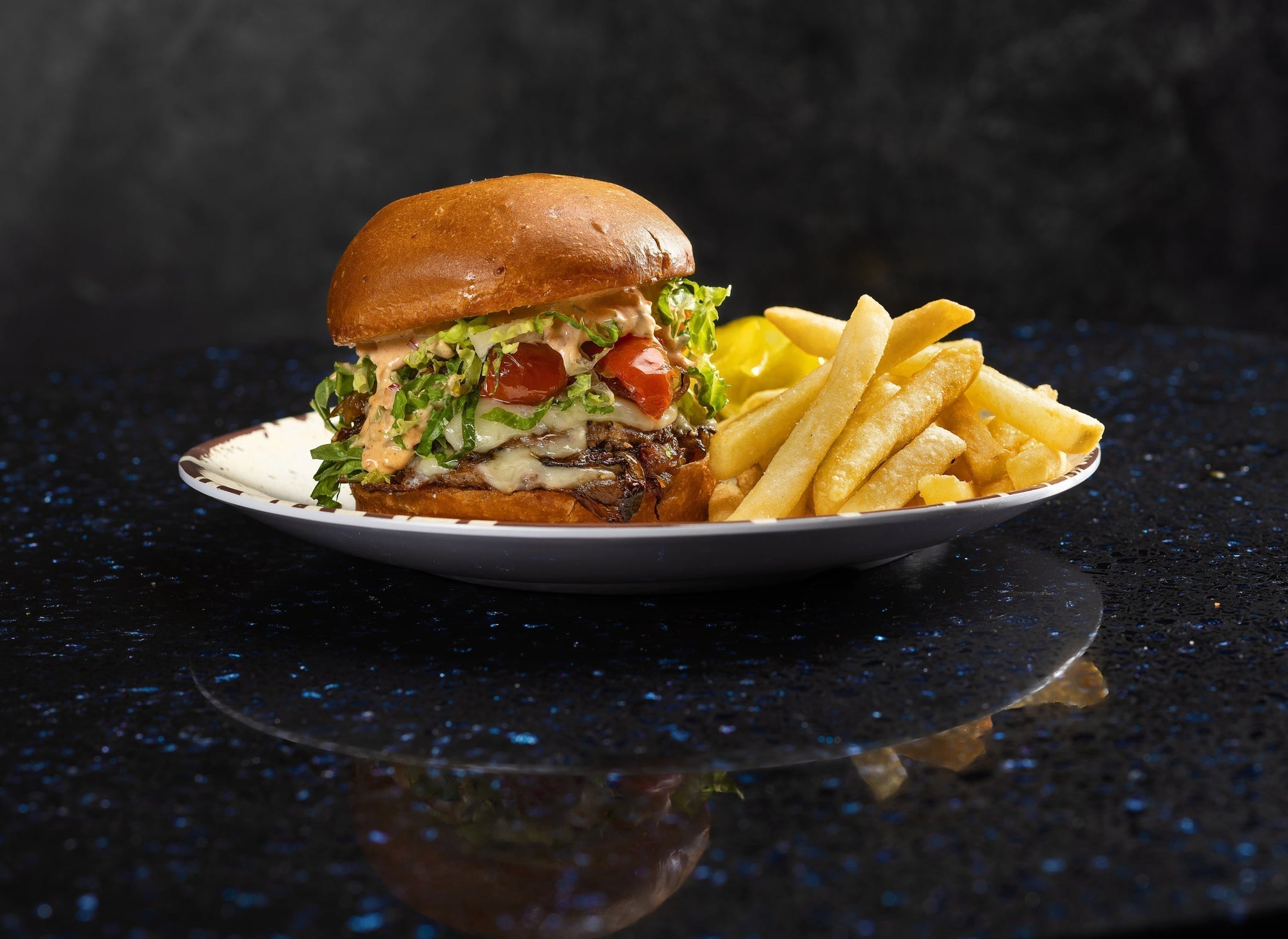 Juicy brunch burger with crispy bacon-onion jam, melty cheese, and a runny fried egg on a toasted bun.