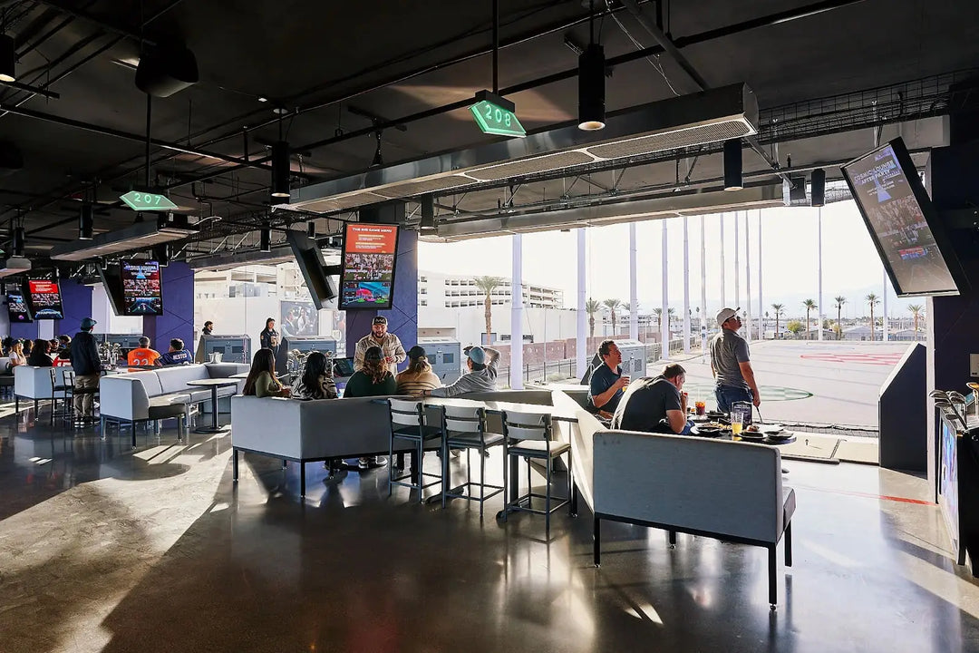 Friends celebrating a birthday party at Atomic Golf Las Vegas with golf games, cocktails, and lively vibes in a private event space.