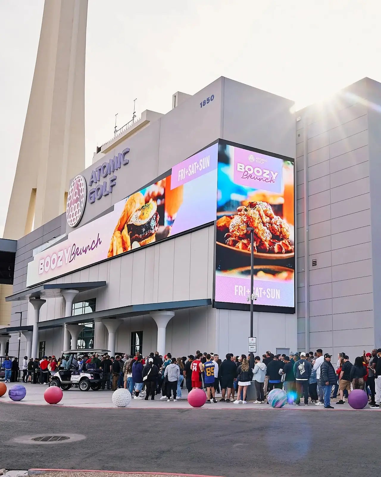 Atomic Golf’s Cosmic Lounge glowing with LED floors and DJ lights, offering a nightlife twist on the Las Vegas golf experience.