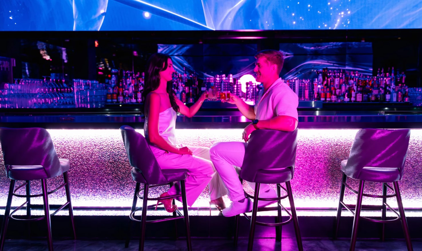 A luxurious bottle service setup at Atomic Golf with premium drinks and cocktails.