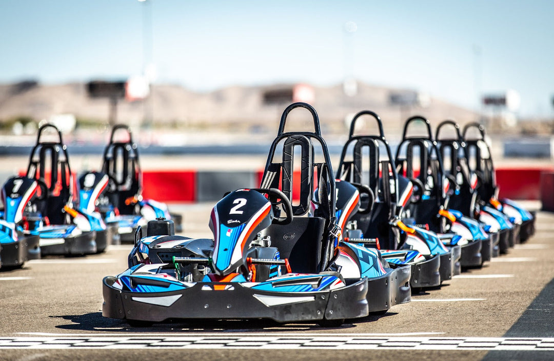 A high-tech Atomic Golf bay compared to a fast-paced go-kart racing track.