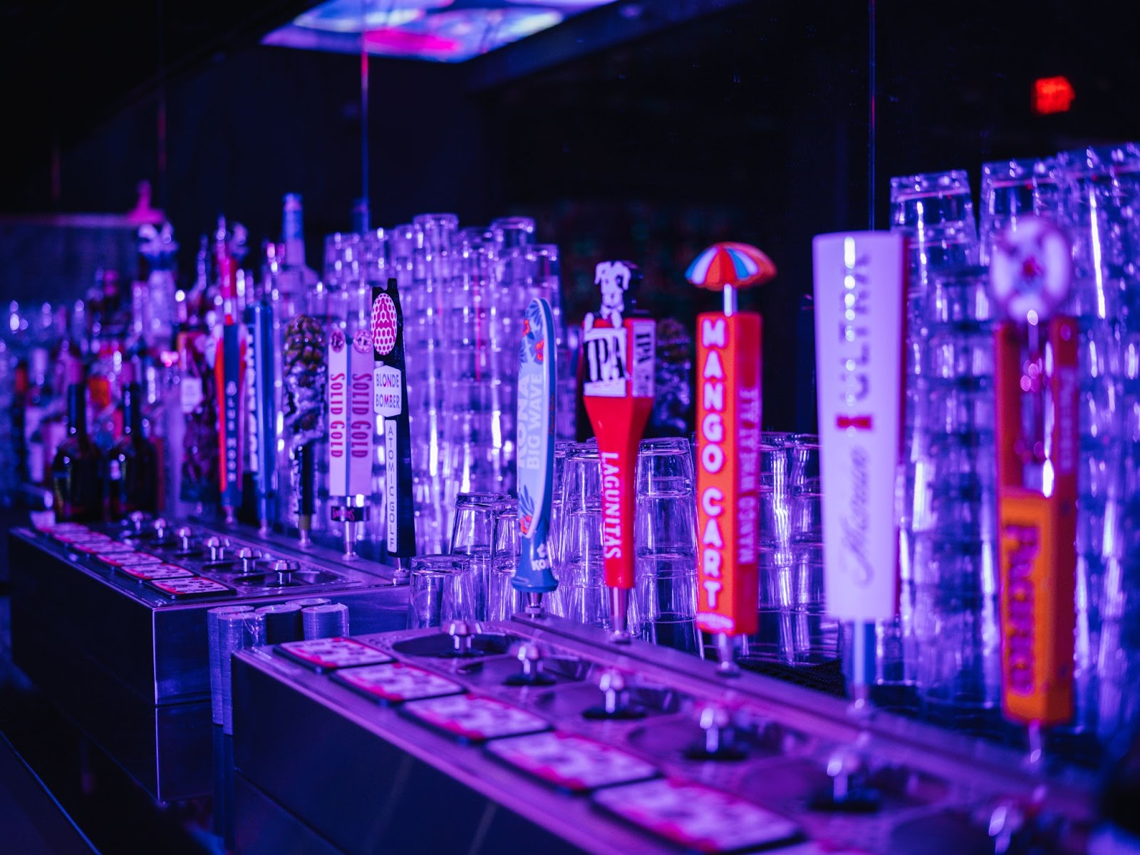 A luxury bottle service setup with champagne, cocktails, and a VIP lounge in a vibrant Las Vegas nightclub.