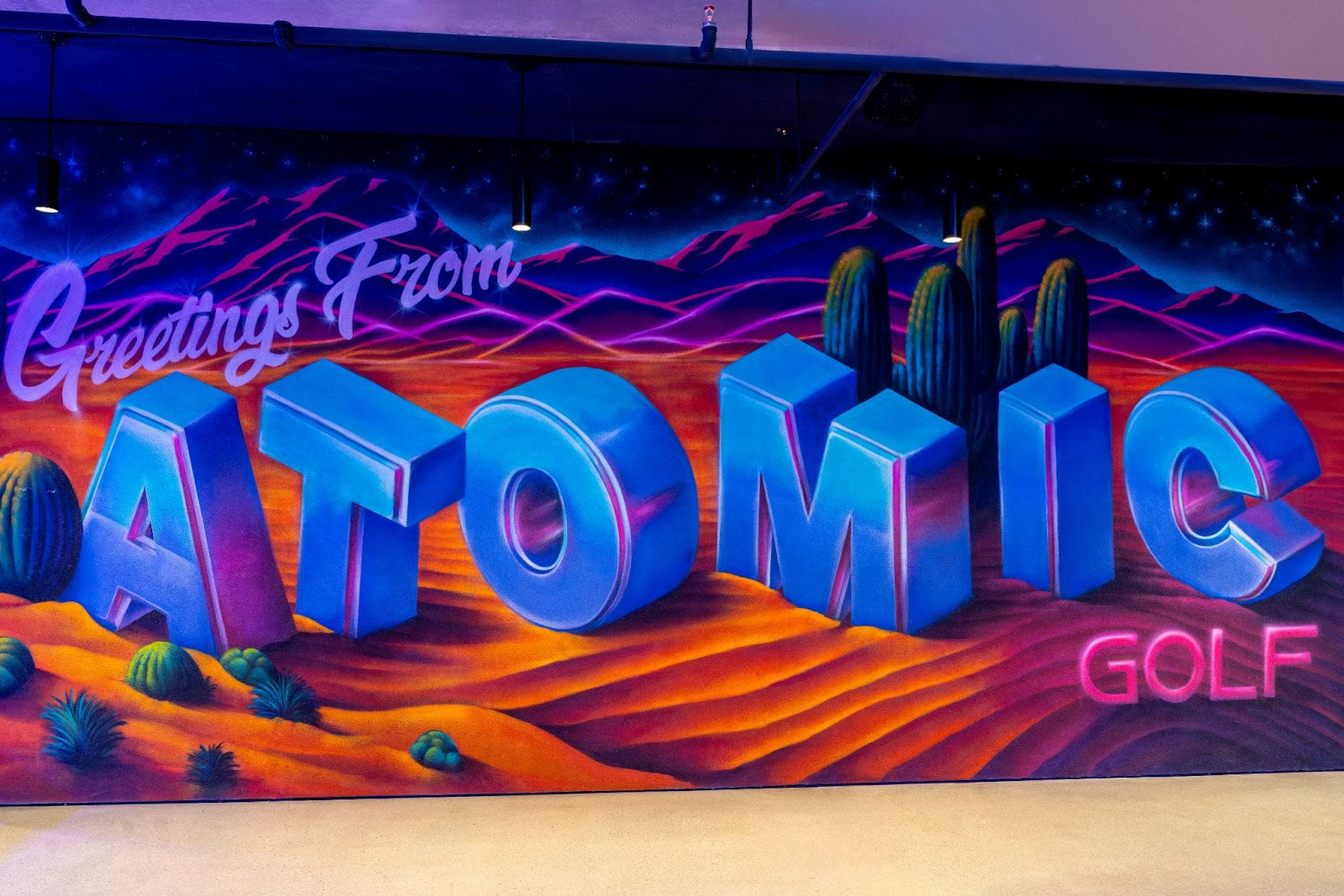 A high-tech Atomic Golf bay alongside a colorful, creatively designed Swingers Crazy Golf course.