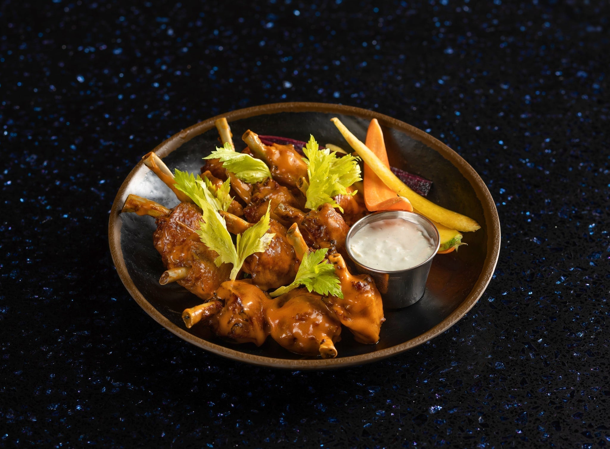 Crispy lollipop wings served with dipping sauce
