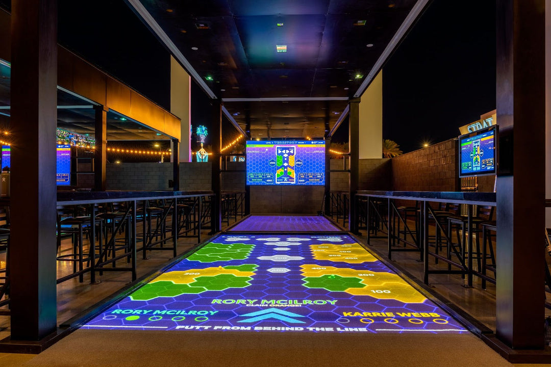 A high-tech Atomic Golf bay alongside a vibrant arcade filled with classic and modern games.