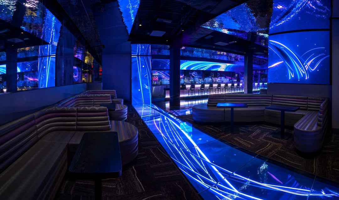 A lively Atomic Golf-themed party in Las Vegas with guests enjoying drinks and golf.