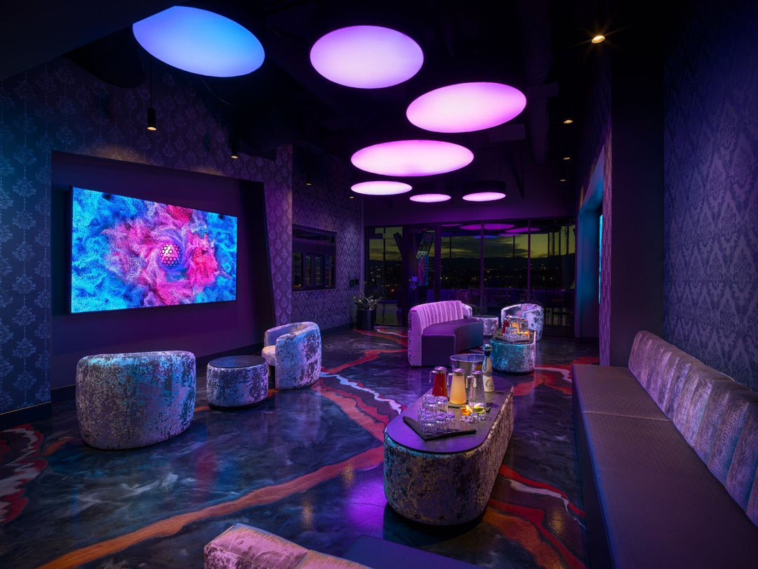 A golfer enjoying a VIP experience at Atomic Golf in Las Vegas with luxury amenities.