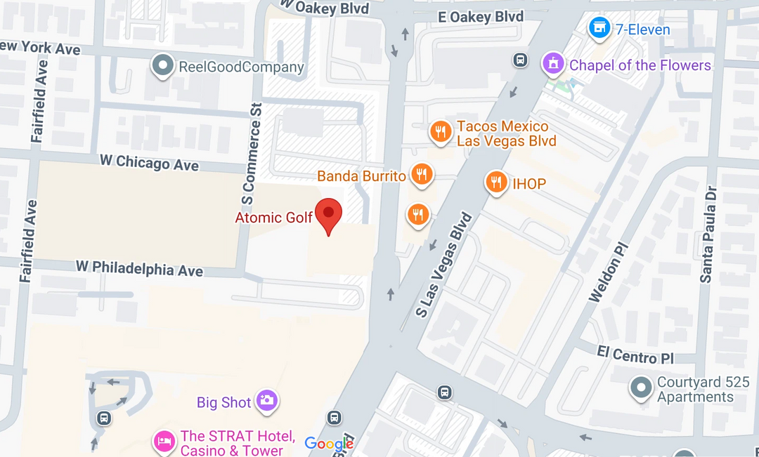 A Google Maps street map showing roads, blocks, and several location markers including Atomic Golf, Banda Burrito, Tacos Mexico Las Vegas Blvd, IHOP, Big Shot, The STRAT Hotel, Casino & Tower, and 7-Eleven.